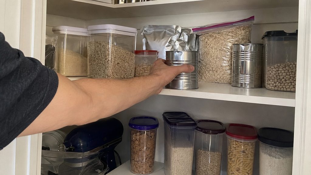 Long-term food storage with rice, oats, beans, pasta, cans, and foil pouches