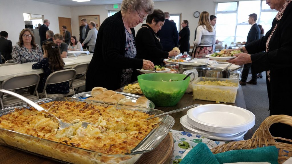 Funeral luncheon with funeral potatoes and food prepared for a grieving family