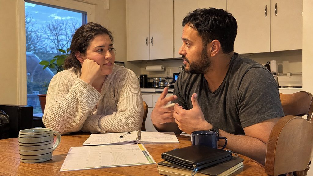 Married couple discussing faith and family life at home