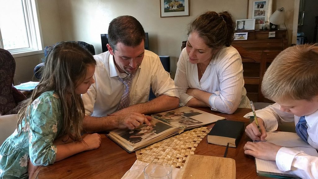 Latter-day Saint family spending Sunday together at home after church